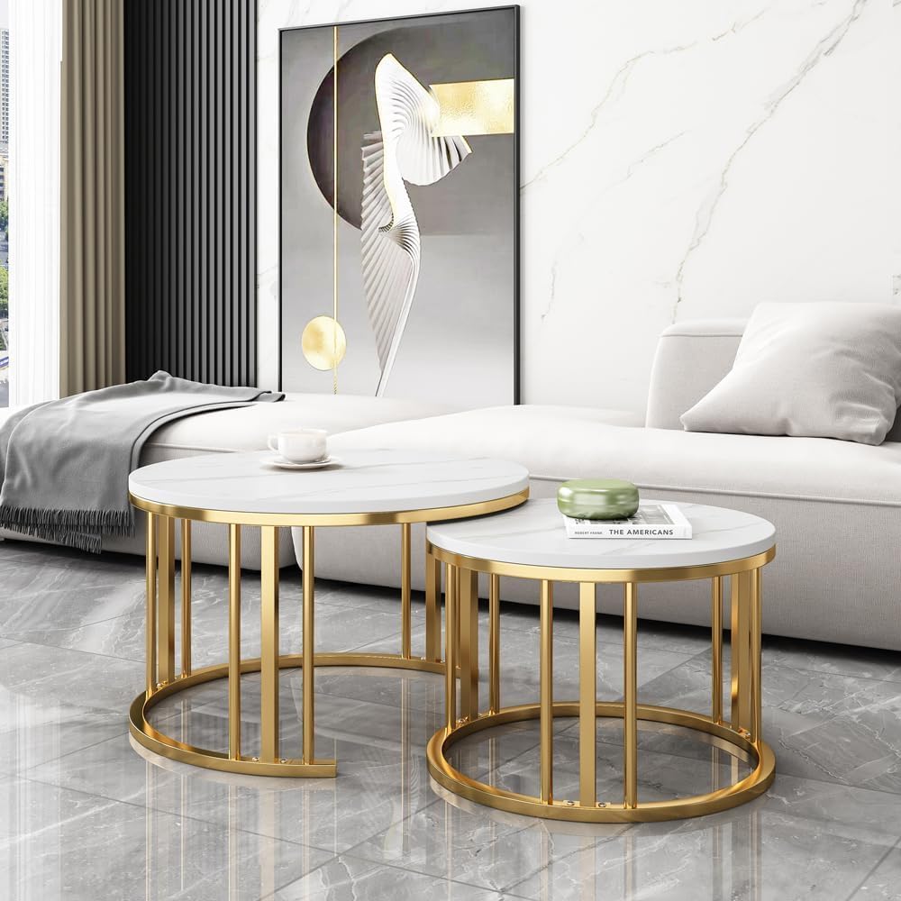 Set of two round marble coffee tables with gold metal frames in a living room Gold White