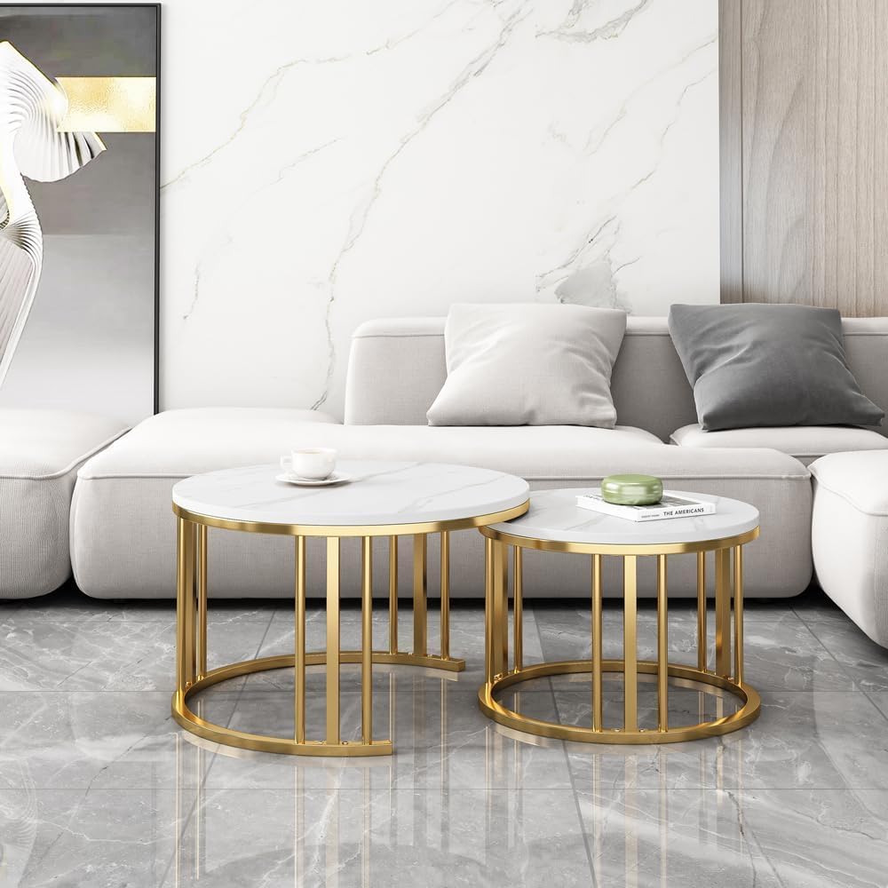 Set of two round marble coffee tables with gold metal frames in a living room Gold White