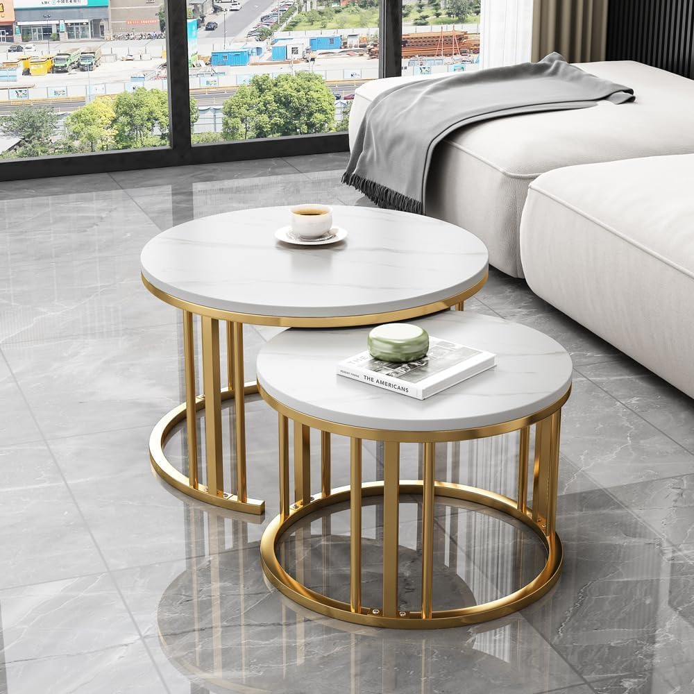 Set of two round marble coffee tables with gold metal frames in a living room Gold White