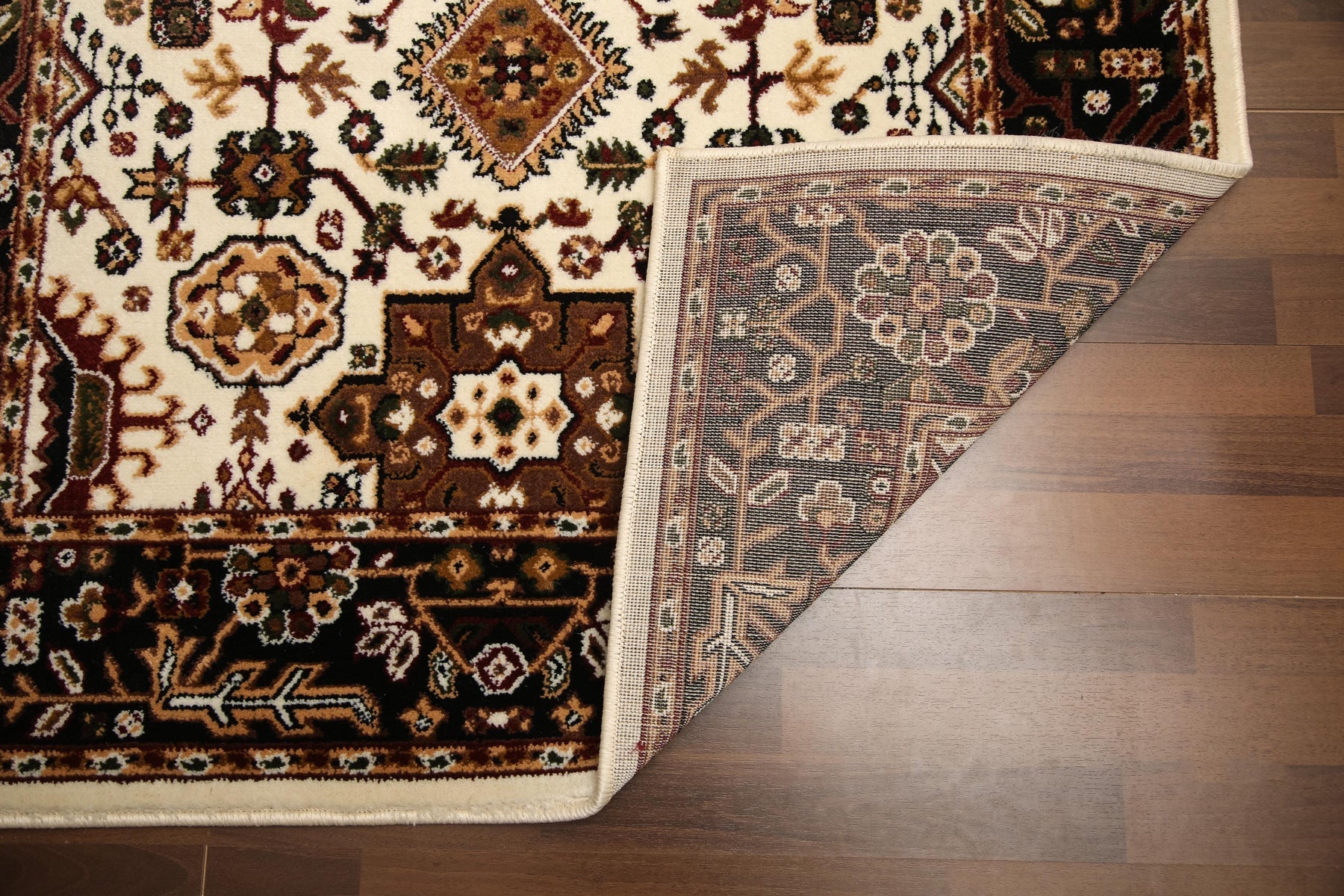 Decorative rug with intricate patterns on a wooden floor