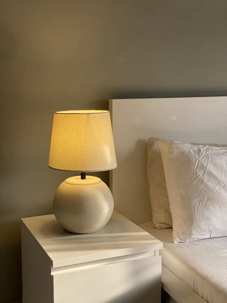 “MELLOW’ lamp with matte-finished terracotta base and black accents, paired with a cream shade – 18-inch handcrafted ceramic lighting.”