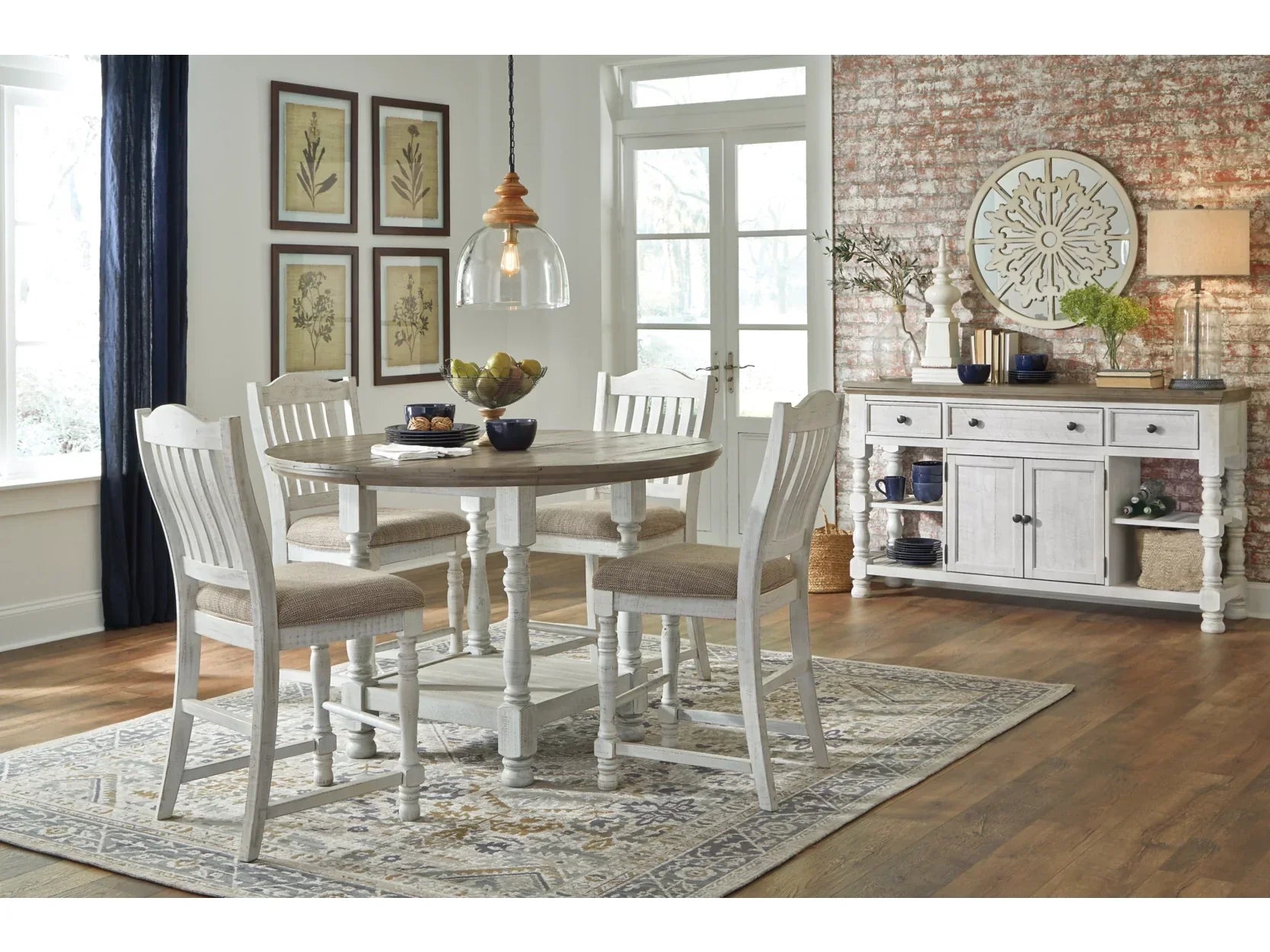 Dining room with a round table and chairs, a sideboard, and decorative elements.
