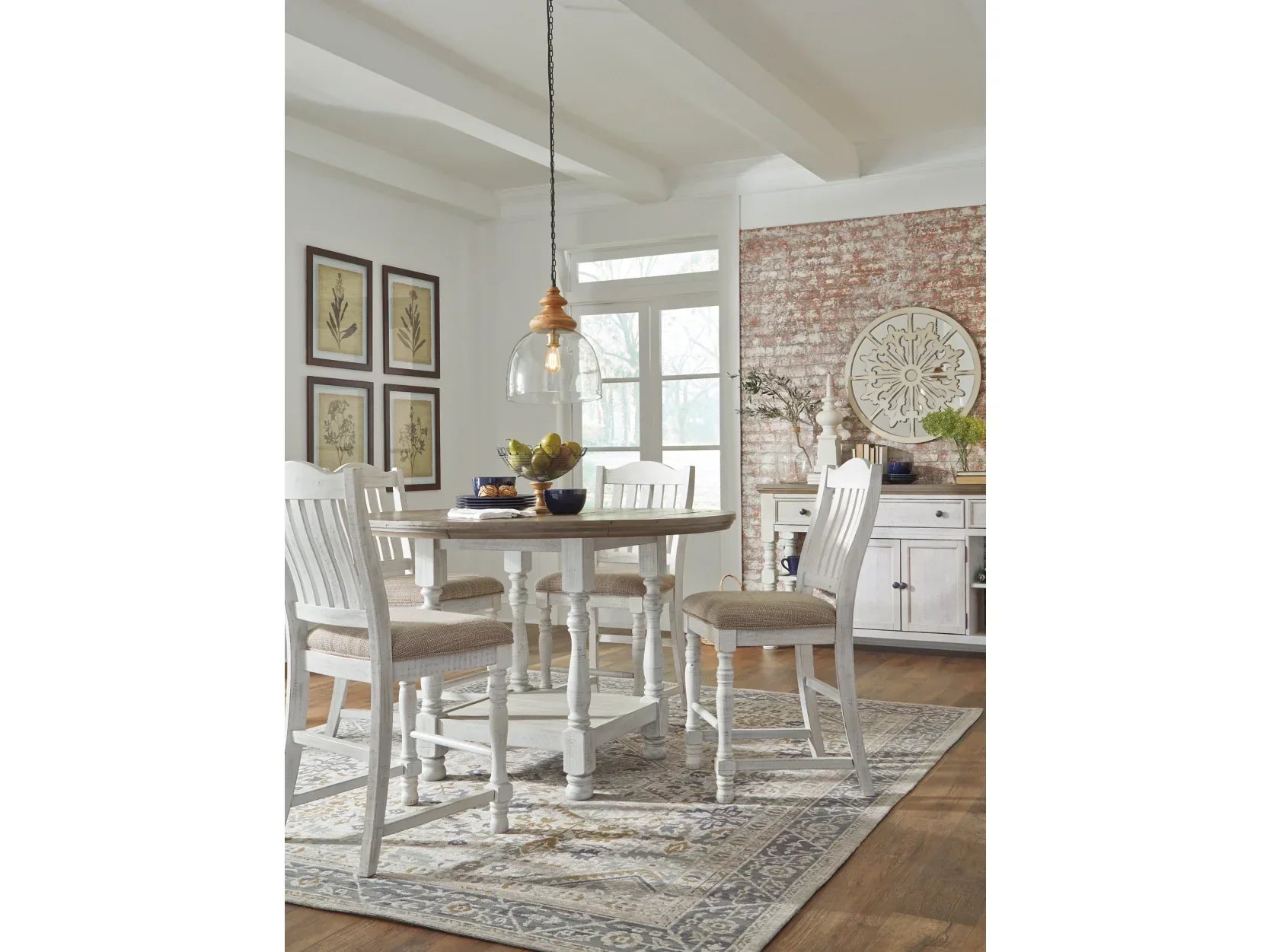 Dining room with a wooden dining table and chairs on a patterned rug.