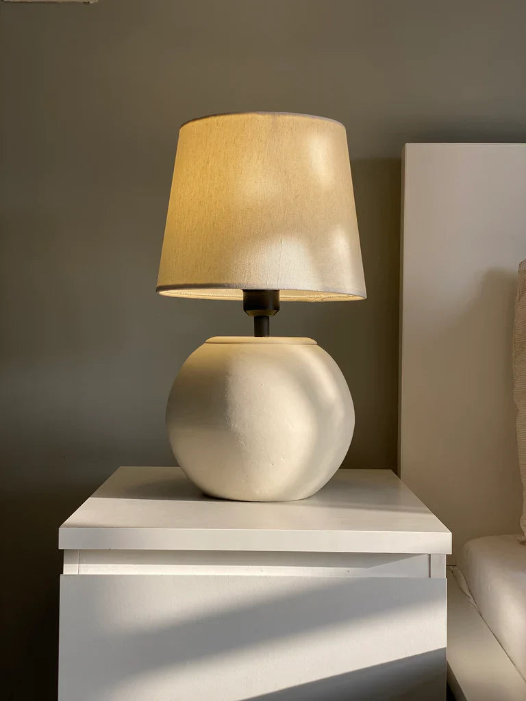 “MELLOW’ lamp with matte-finished terracotta base and black accents, paired with a cream shade – 18-inch handcrafted ceramic lighting.”