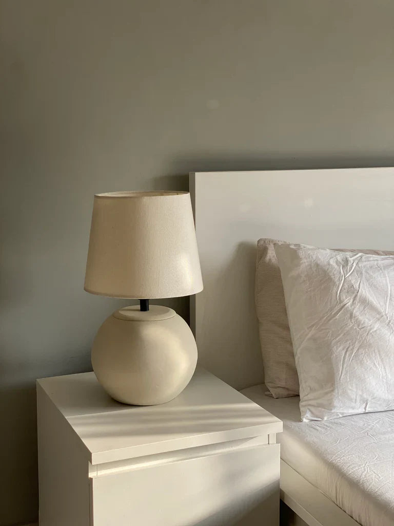 “MELLOW’ lamp with matte-finished terracotta base and black accents, paired with a cream shade – 18-inch handcrafted ceramic lighting.”