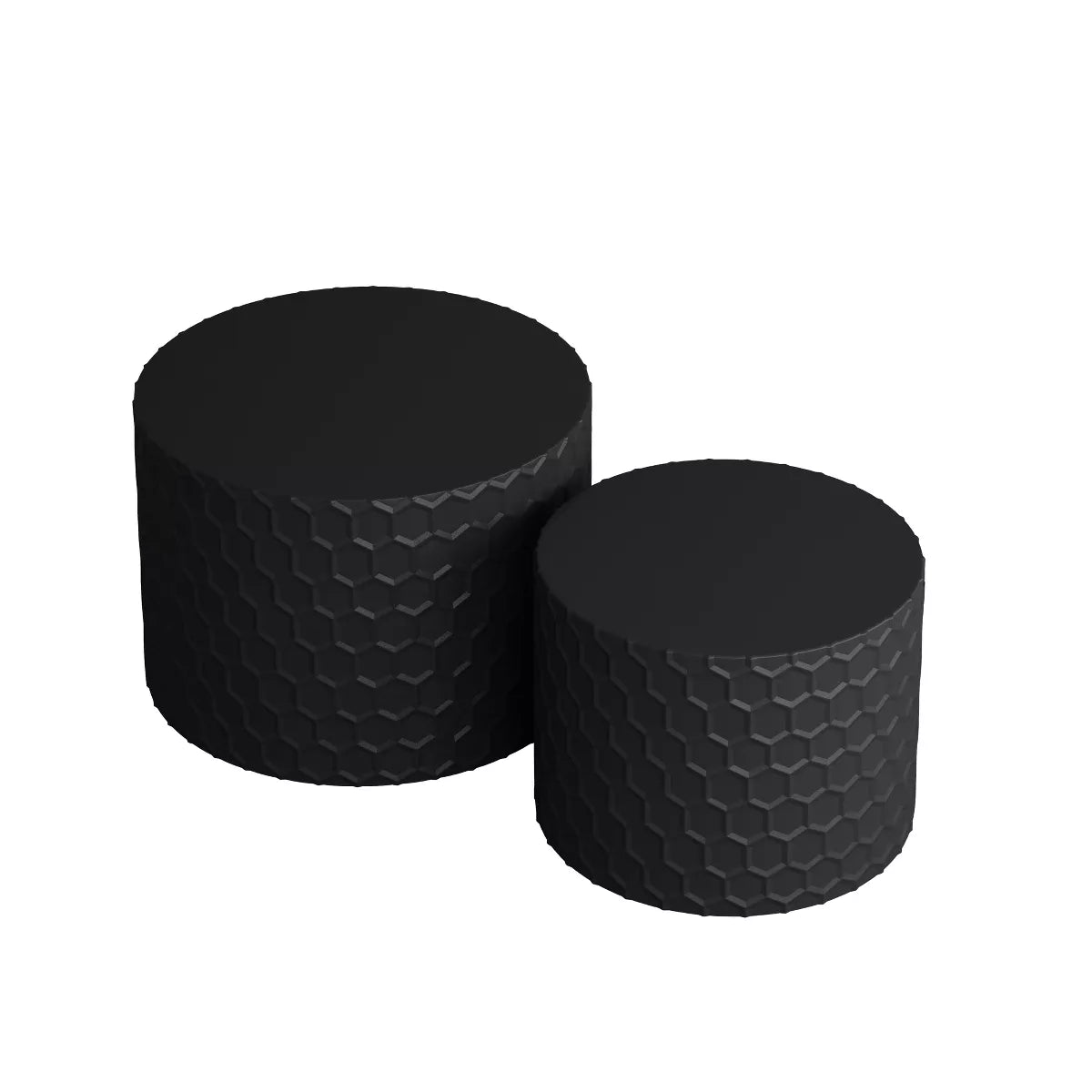 Two black textured side tables in front of a beige sofa with decorative pillows. black
