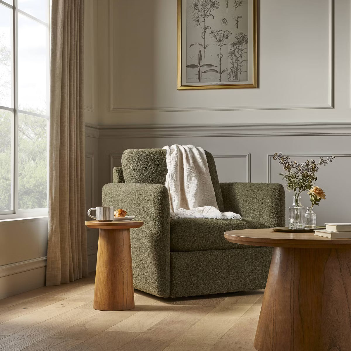 A greenish brown colored armchair with a textured fabric and square shape, placed on a light gray floor.