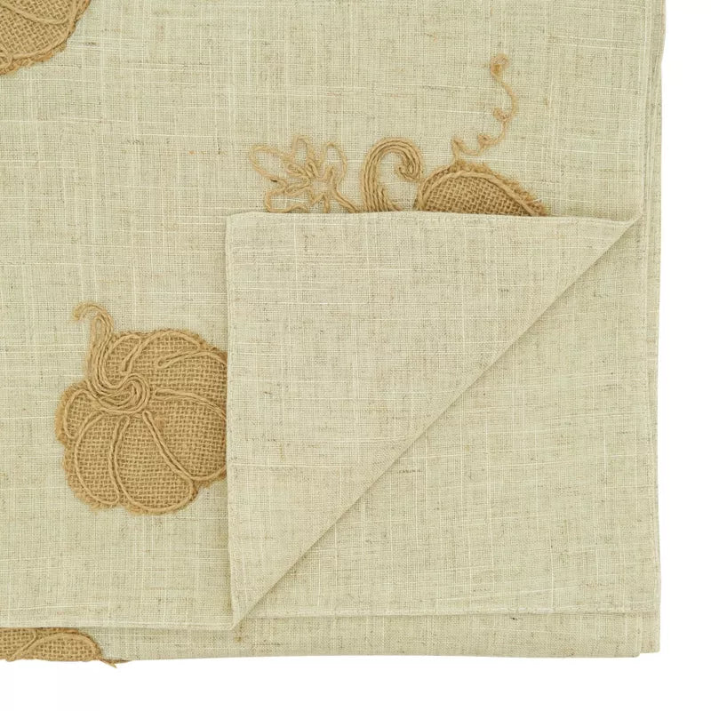 Beige fabric with embroidered patterns on a white background