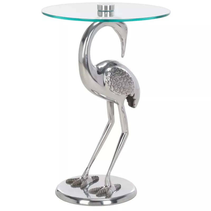 Flamingo-shaped side table with glass top on a white background