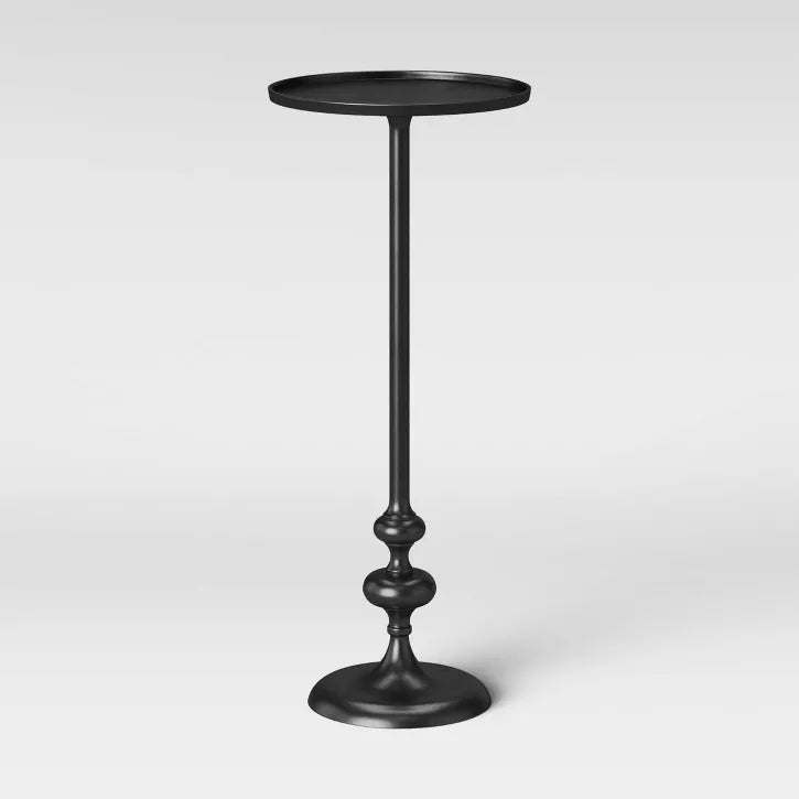 Black pedestal table on a white background