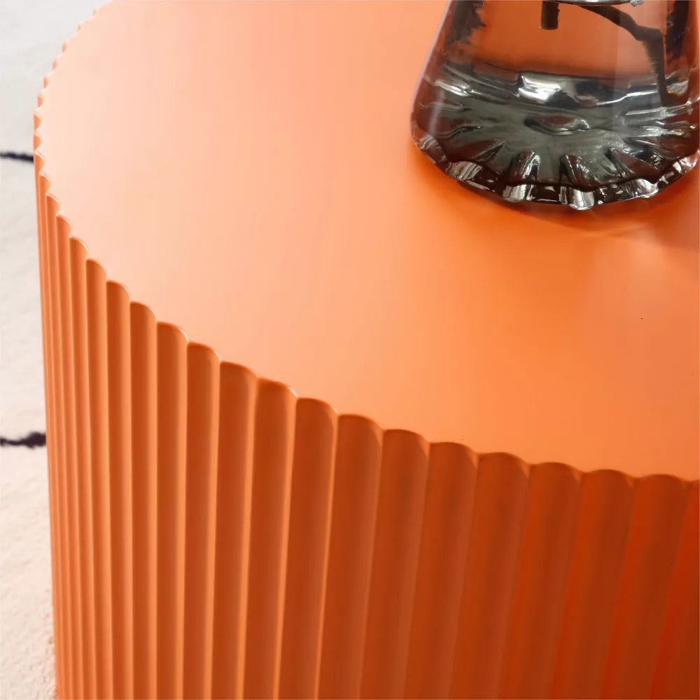 Close-up of an orange textured container with a clear lid on a light background orange