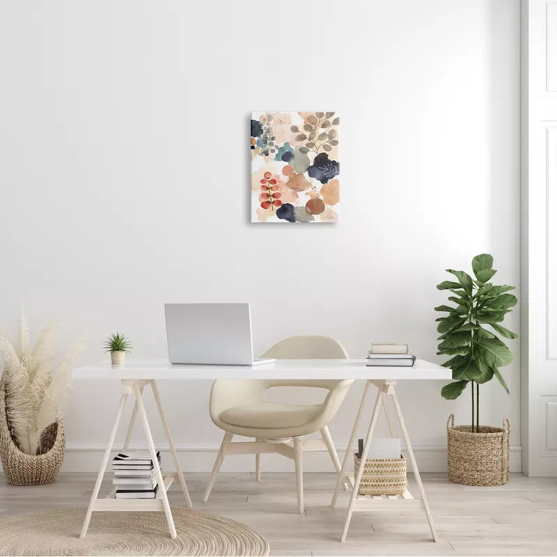 Modern home office with a white desk, chair, laptop, and decorative plants.