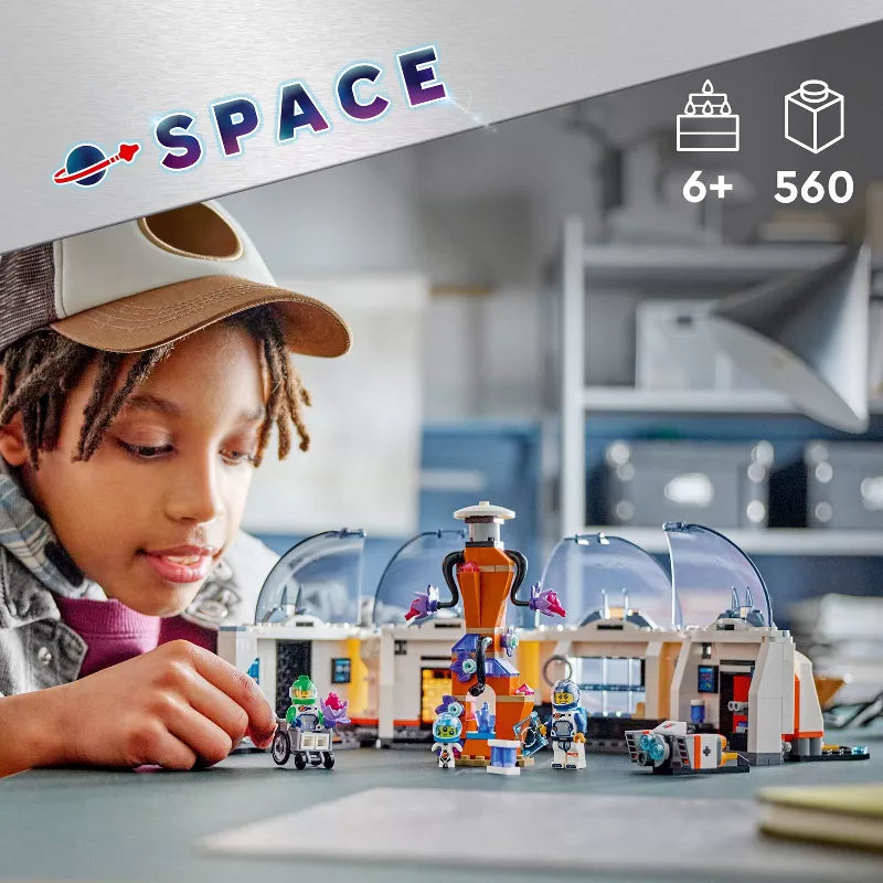 Child playing with a space-themed toy set, with 'Space' branding and product details.