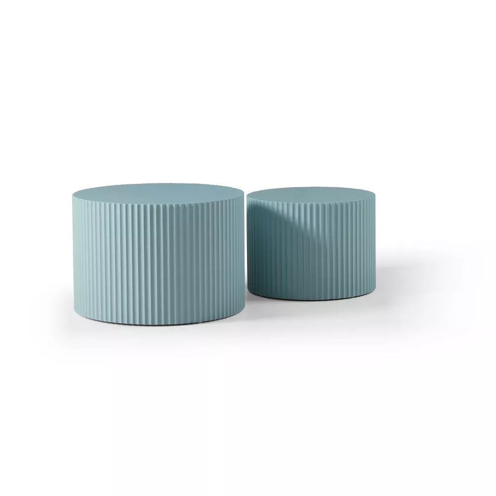 Blue ribbed side table with a magazine on top, featuring a plant and white vase.blue