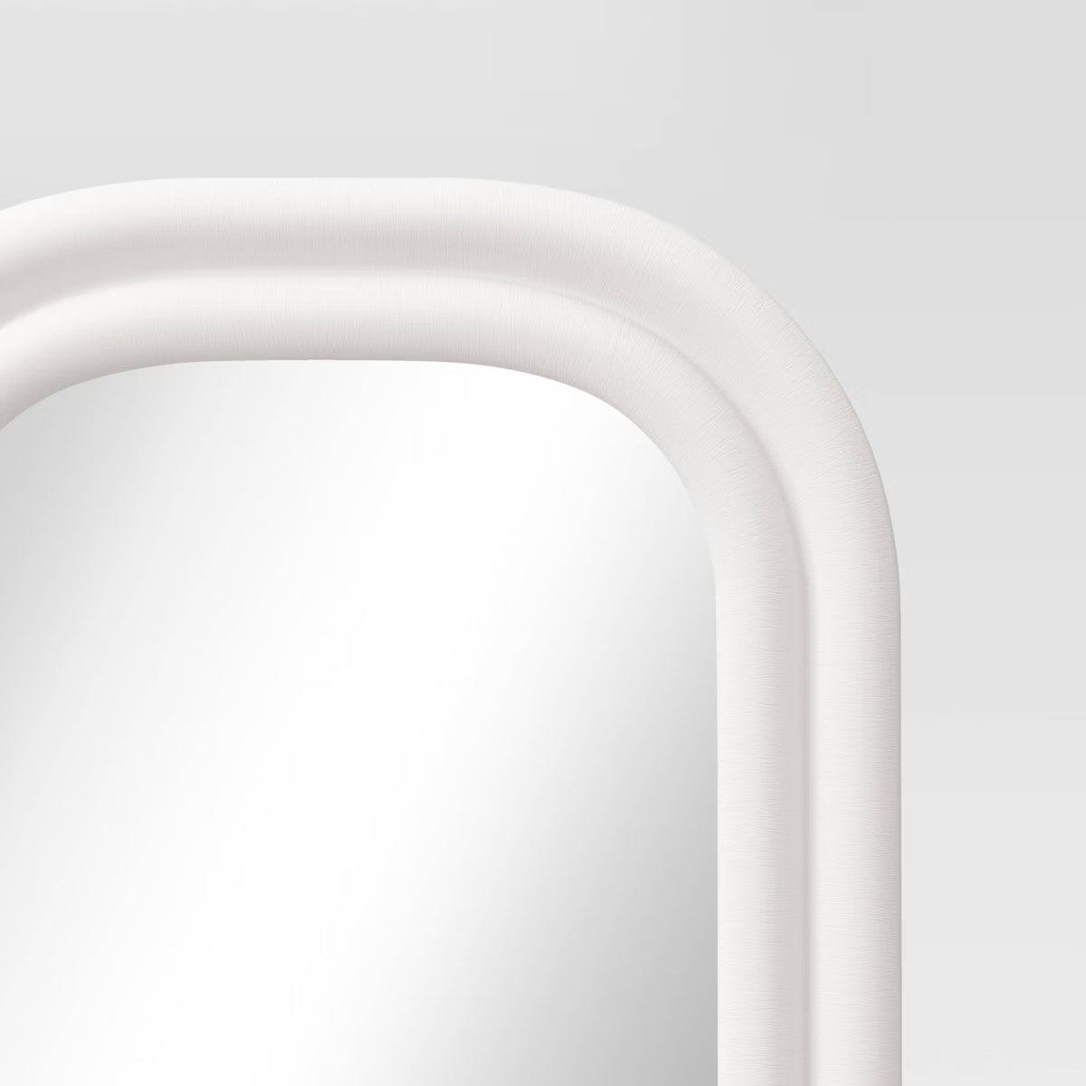 A white colored mirror with a rounded rectangular frame against a light gray background.