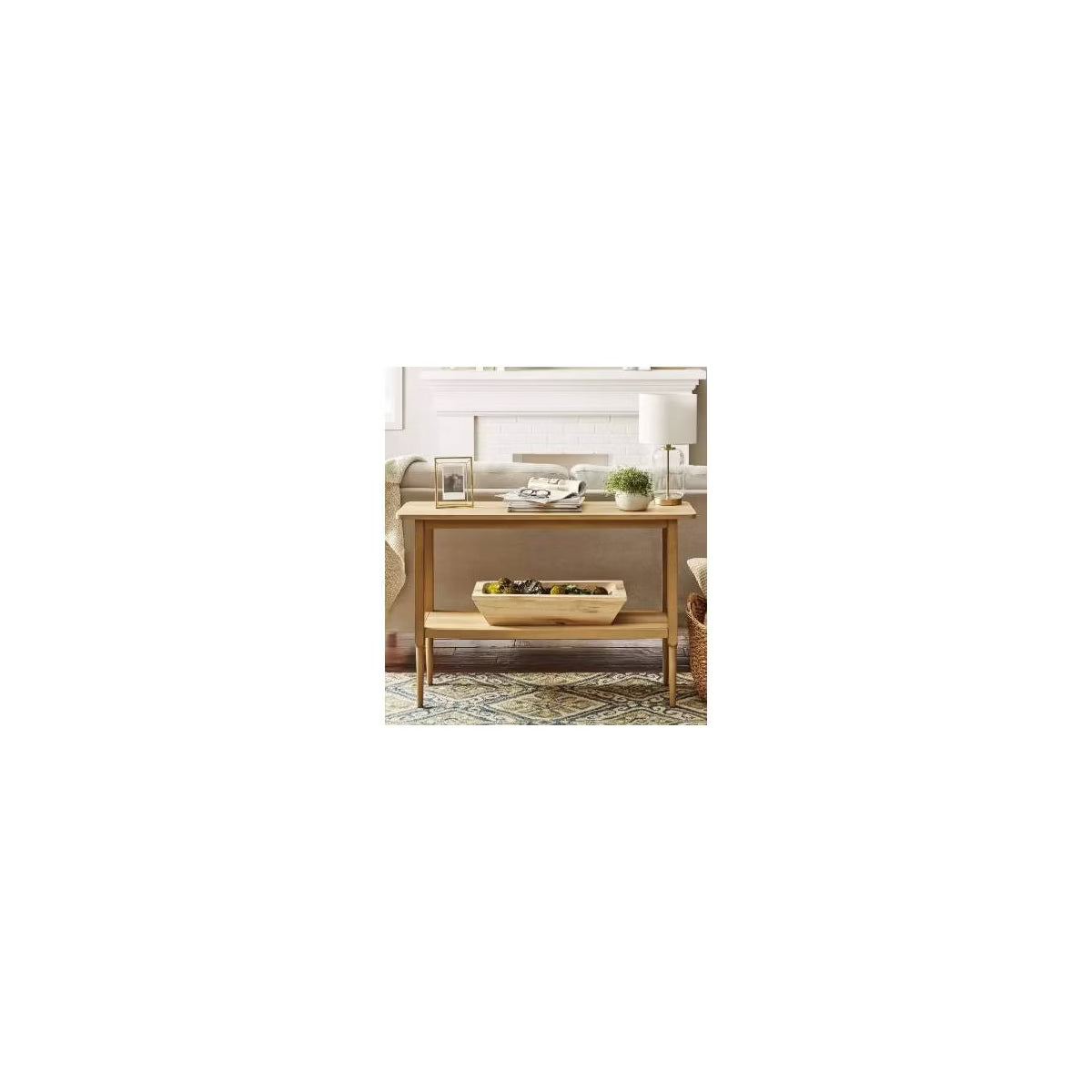 A light brown colored rectangular table with four slender legs and a lower shelf.
