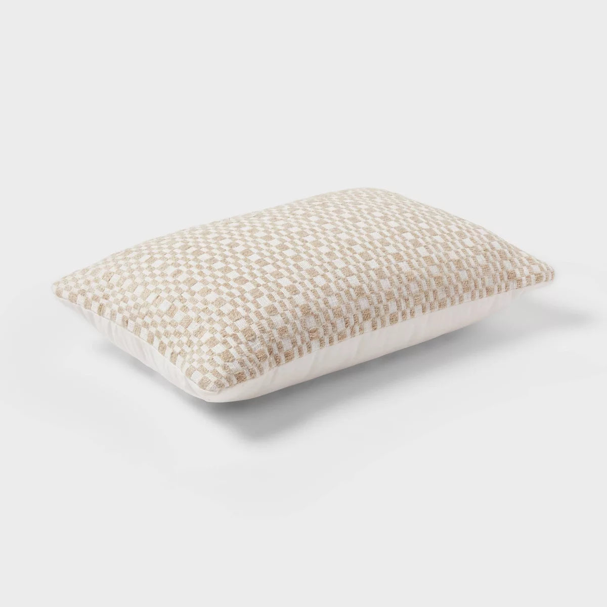 A rectangular throw pillow with a textured woven checkerboard pattern in cream and beige, shown against a light gray background with a soft drop shadow.