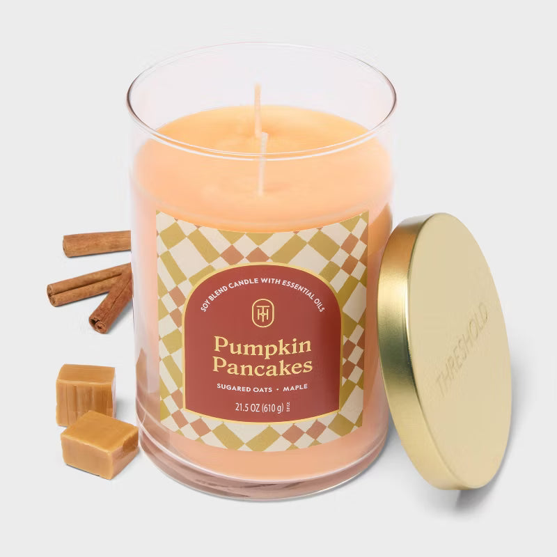 Candle labeled 'Pumpkin Pancakes' with cinnamon sticks and caramel pieces on a light background 21.5oz
