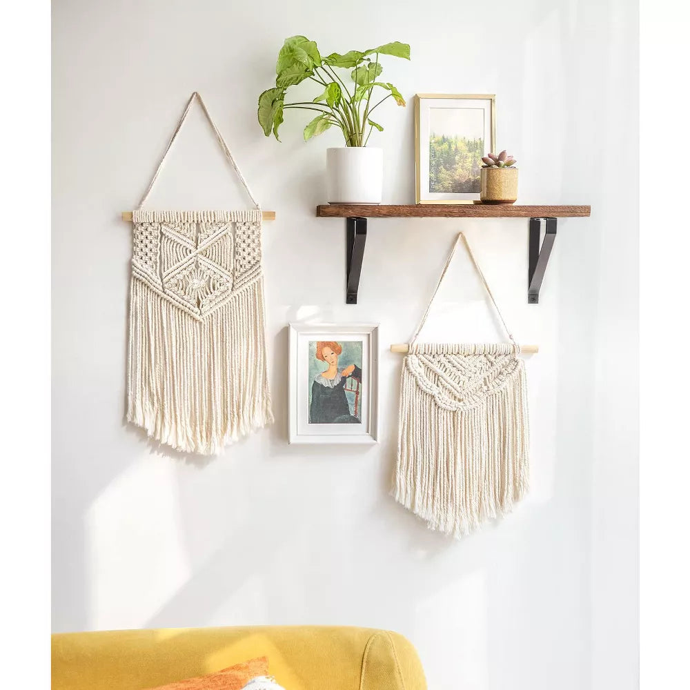 Macrame wall hanging with geometric pattern on a white background