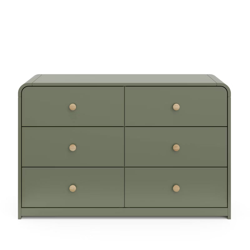 Green dresser with four drawers and wooden knobs on a white background
