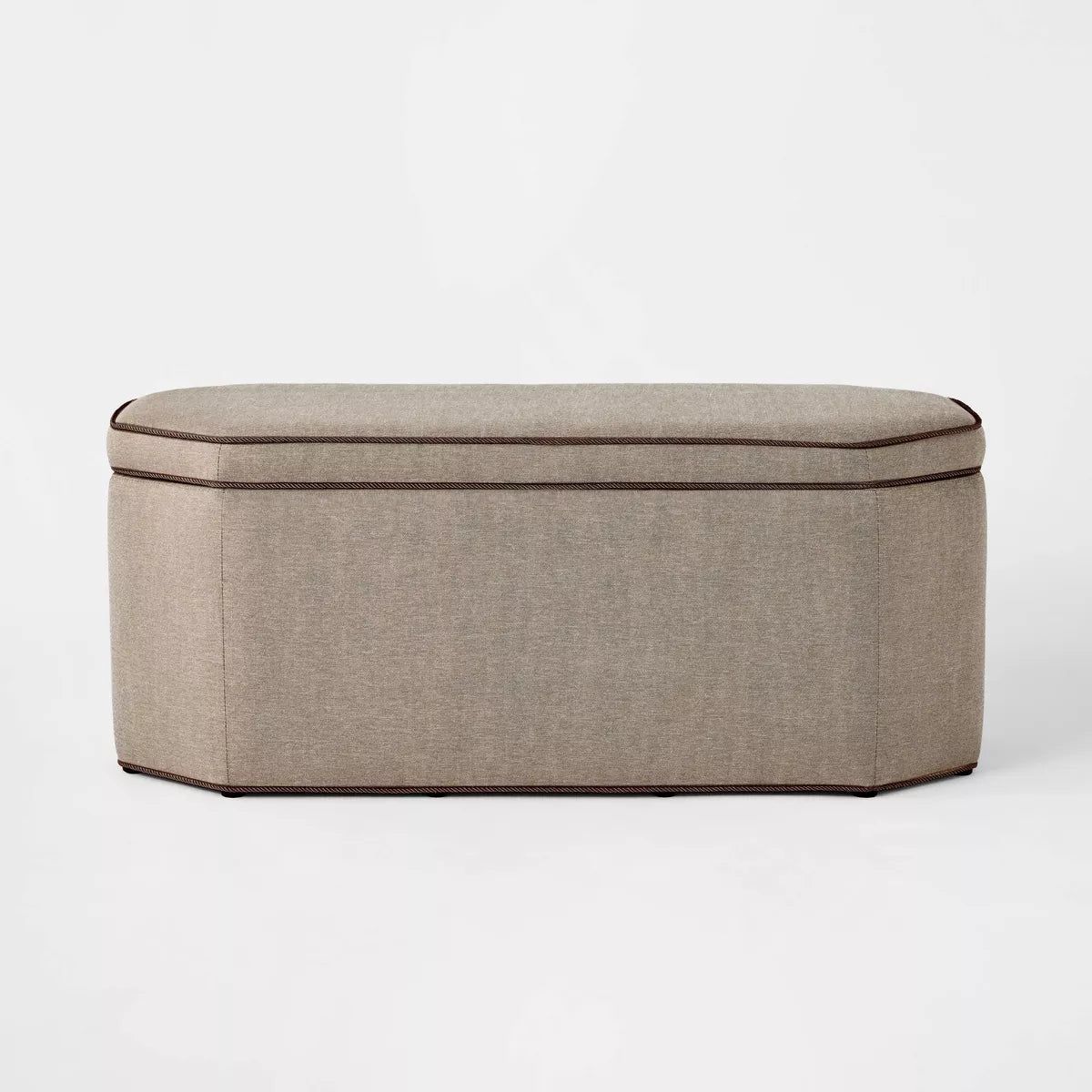 Side profile view of the brown linen hexagon storage bench