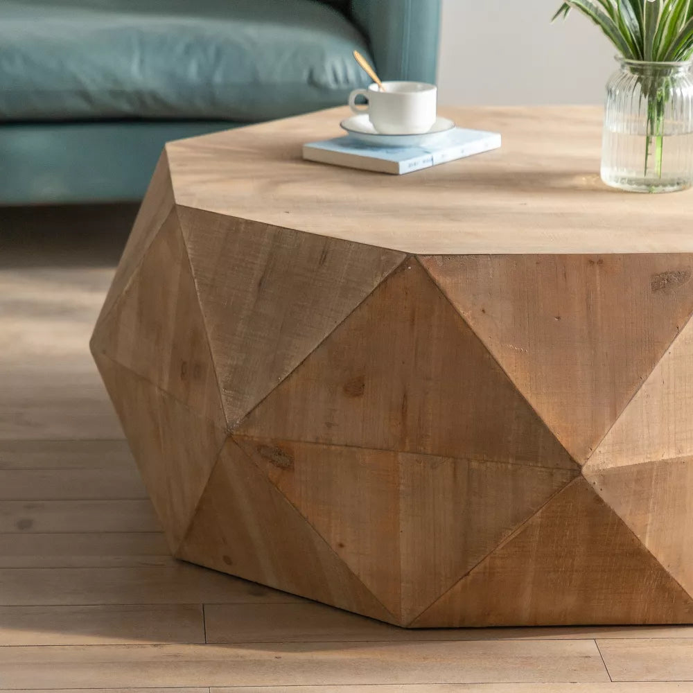 Hexagonal wooden coffee table with a cup, saucer, and flowers on a wooden floor.