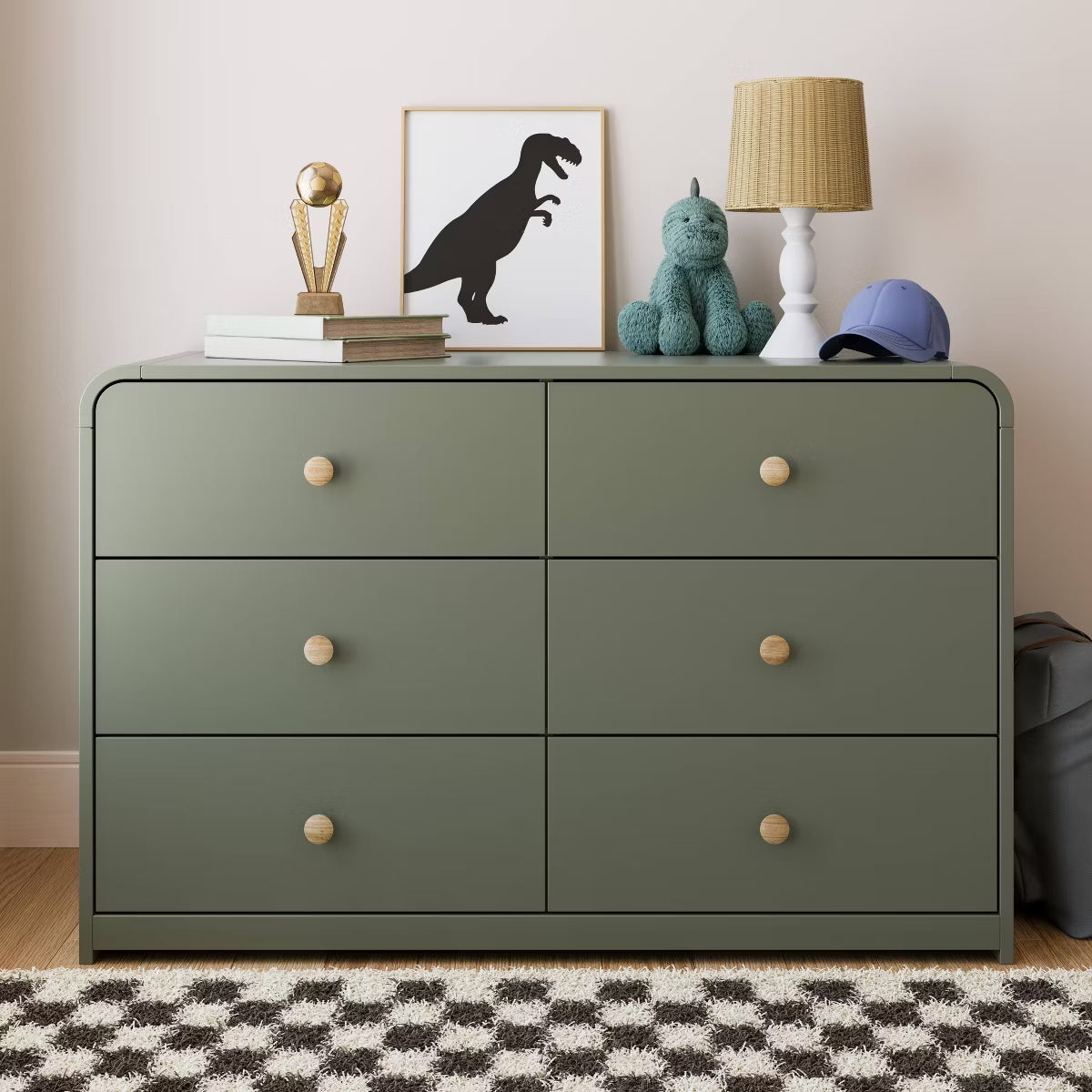 Green dresser with decorative items in a room setting