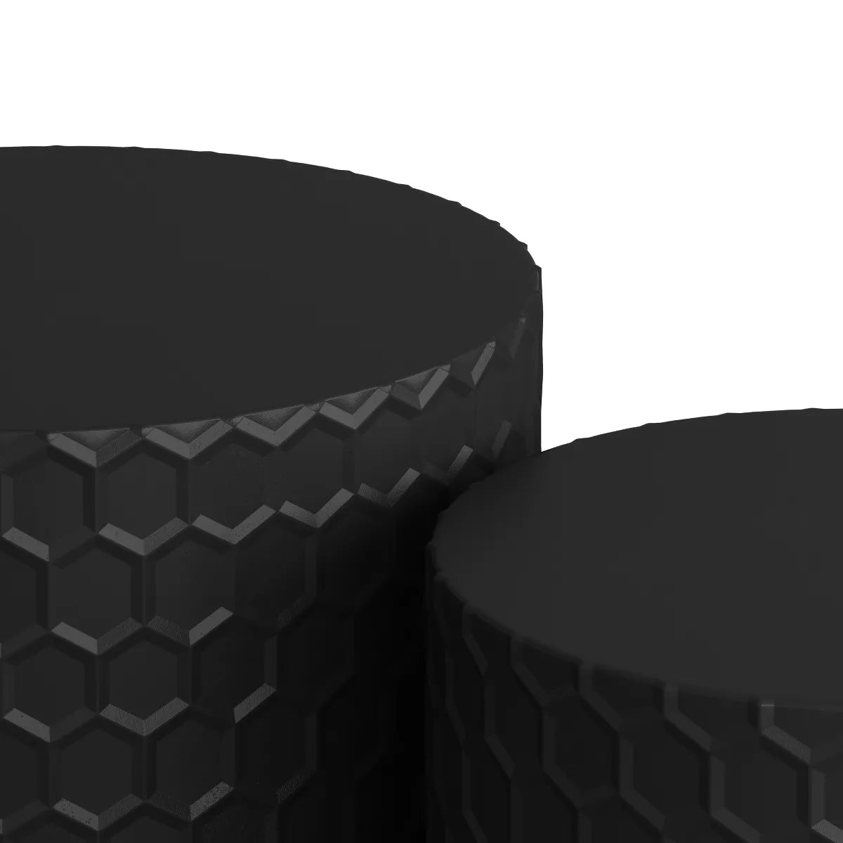 Two black textured side tables in front of a beige sofa with decorative pillows. black