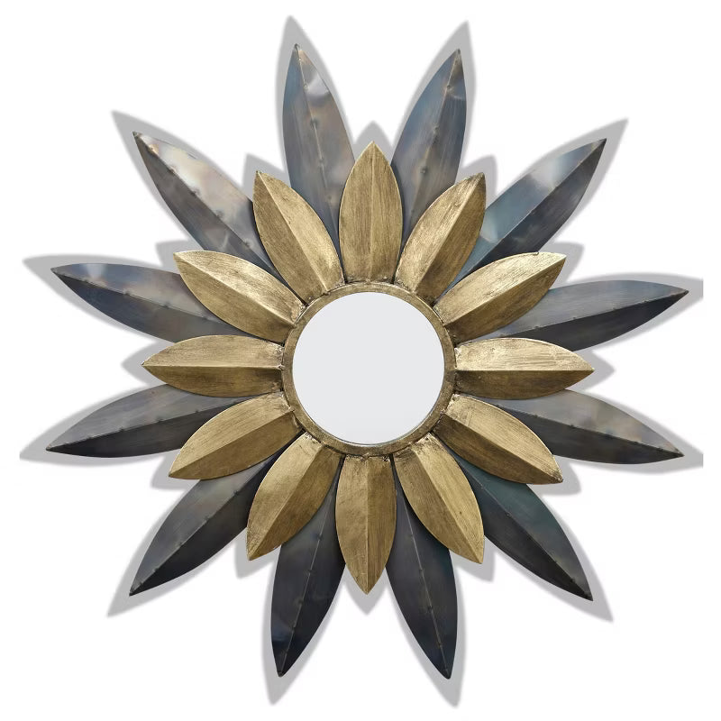 Decorative sun-shaped mirror with gold and black petals on a white background