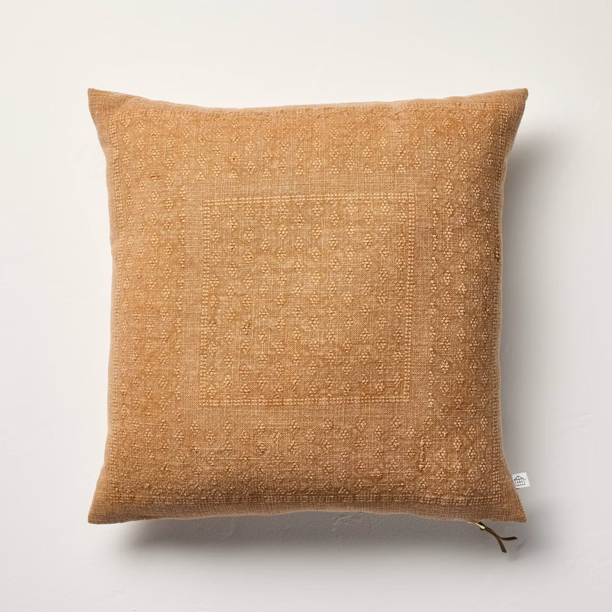 Brown textured pillow with a zipper on a light gray background Natural