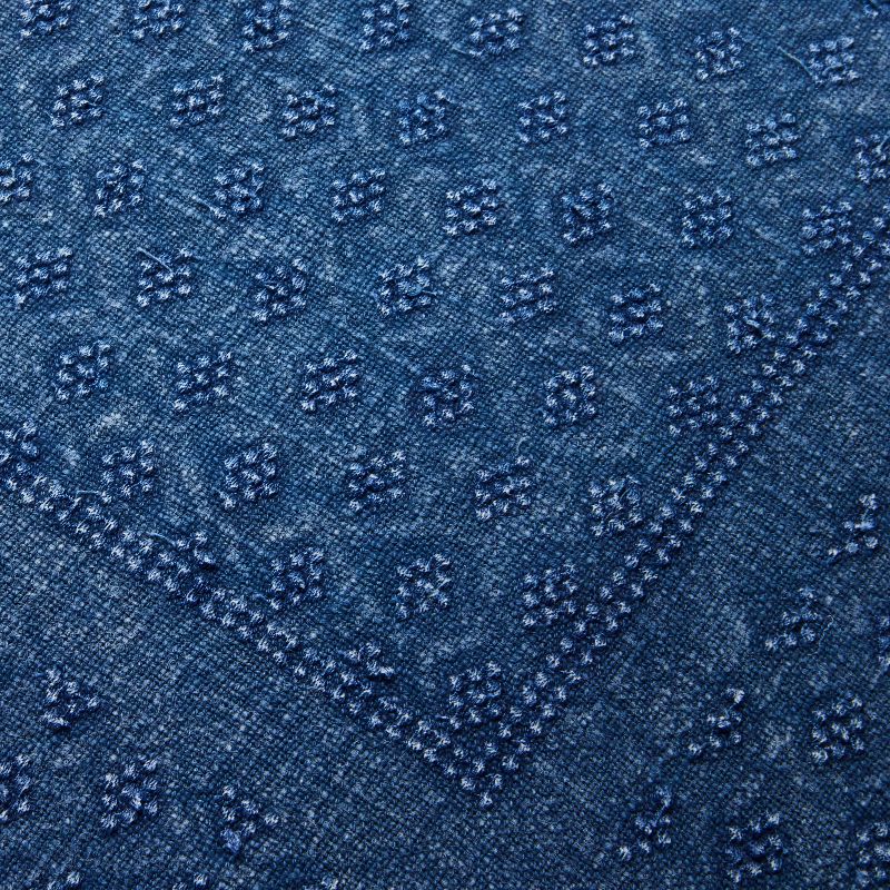 Blue textured pillow on a light gray background Navy