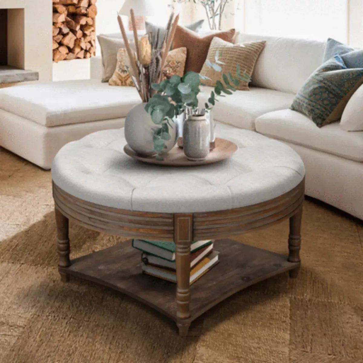 Round wooden coffee table with a gray cushion in a living room setting. gray