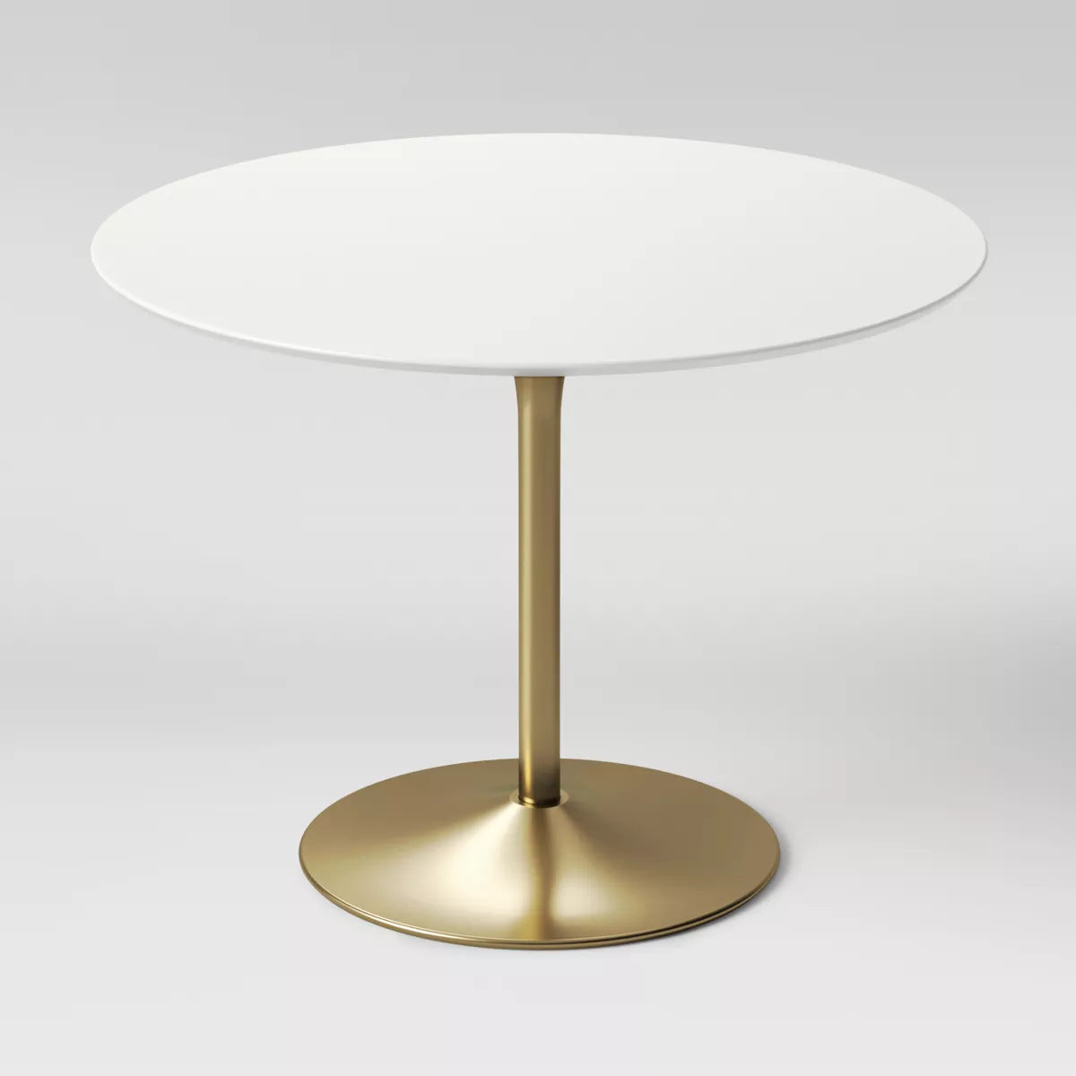 Round table with a white top and gold base on a light gray background