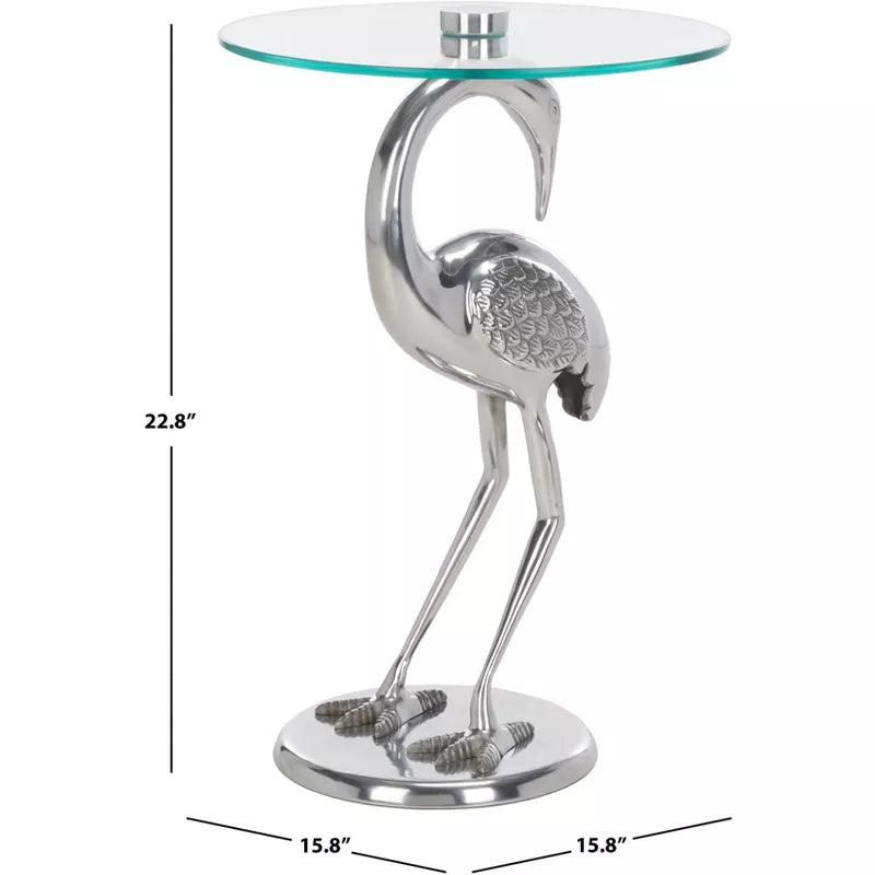 Flamingo-shaped side table with glass top and measurements on a white background