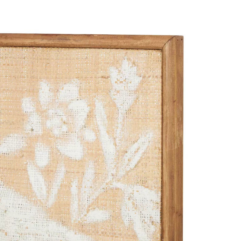 Framed artwork with white floral design on a beige background