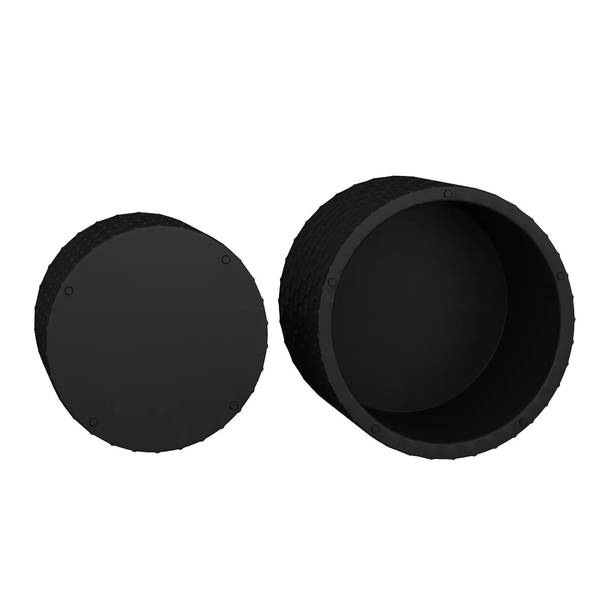 Two black textured side tables in front of a beige sofa with decorative pillows. black