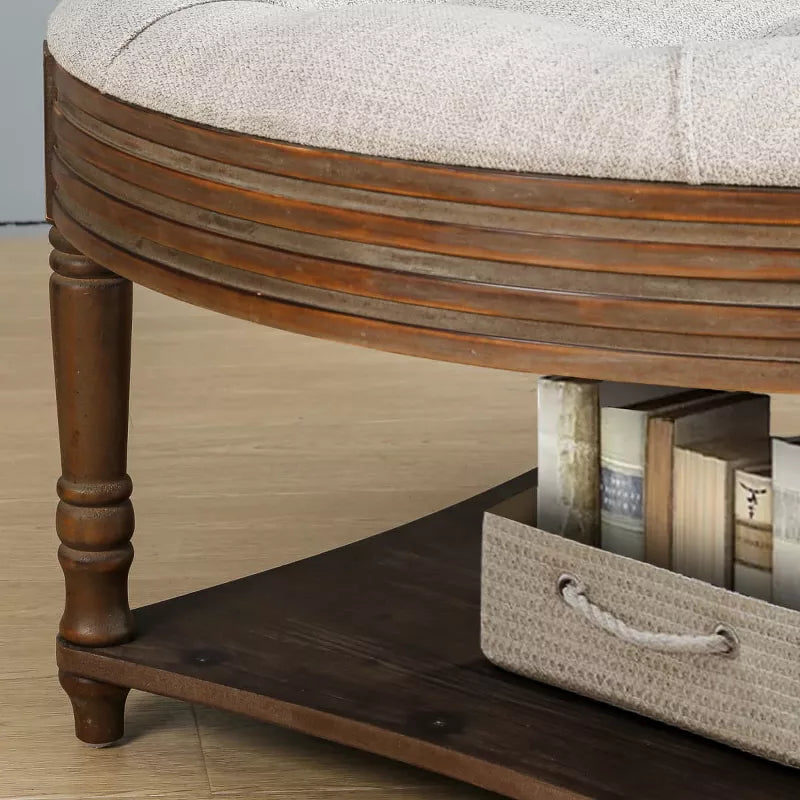 Round wooden coffee table with a gray cushion in a living room setting. gray