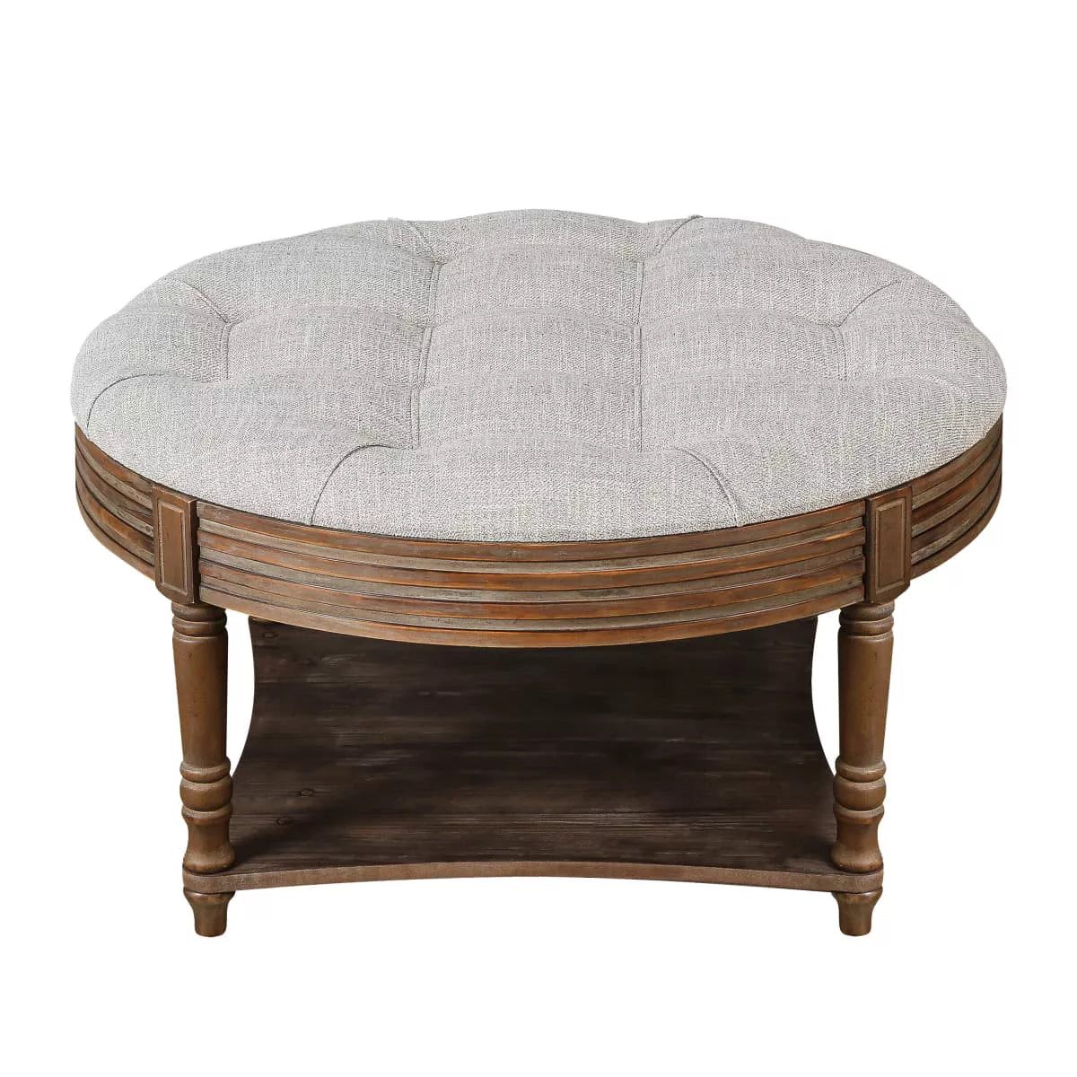 Round wooden coffee table with a gray cushion in a living room setting. gray