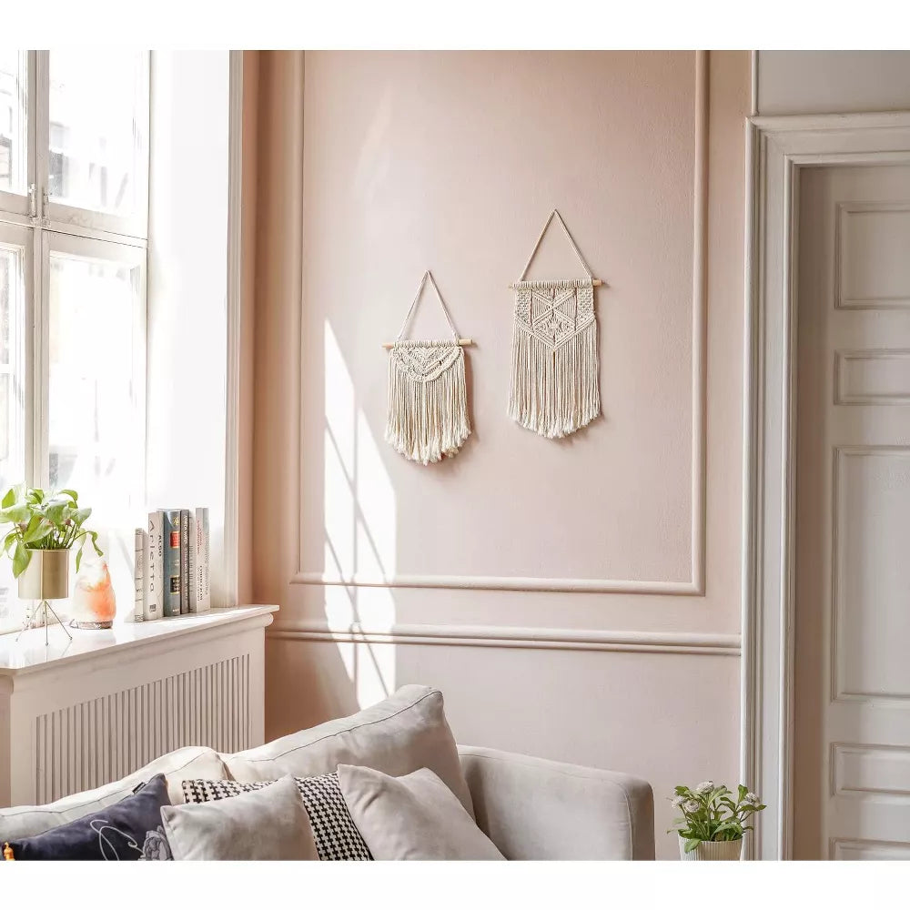 Macrame wall hanging with geometric pattern on a white background