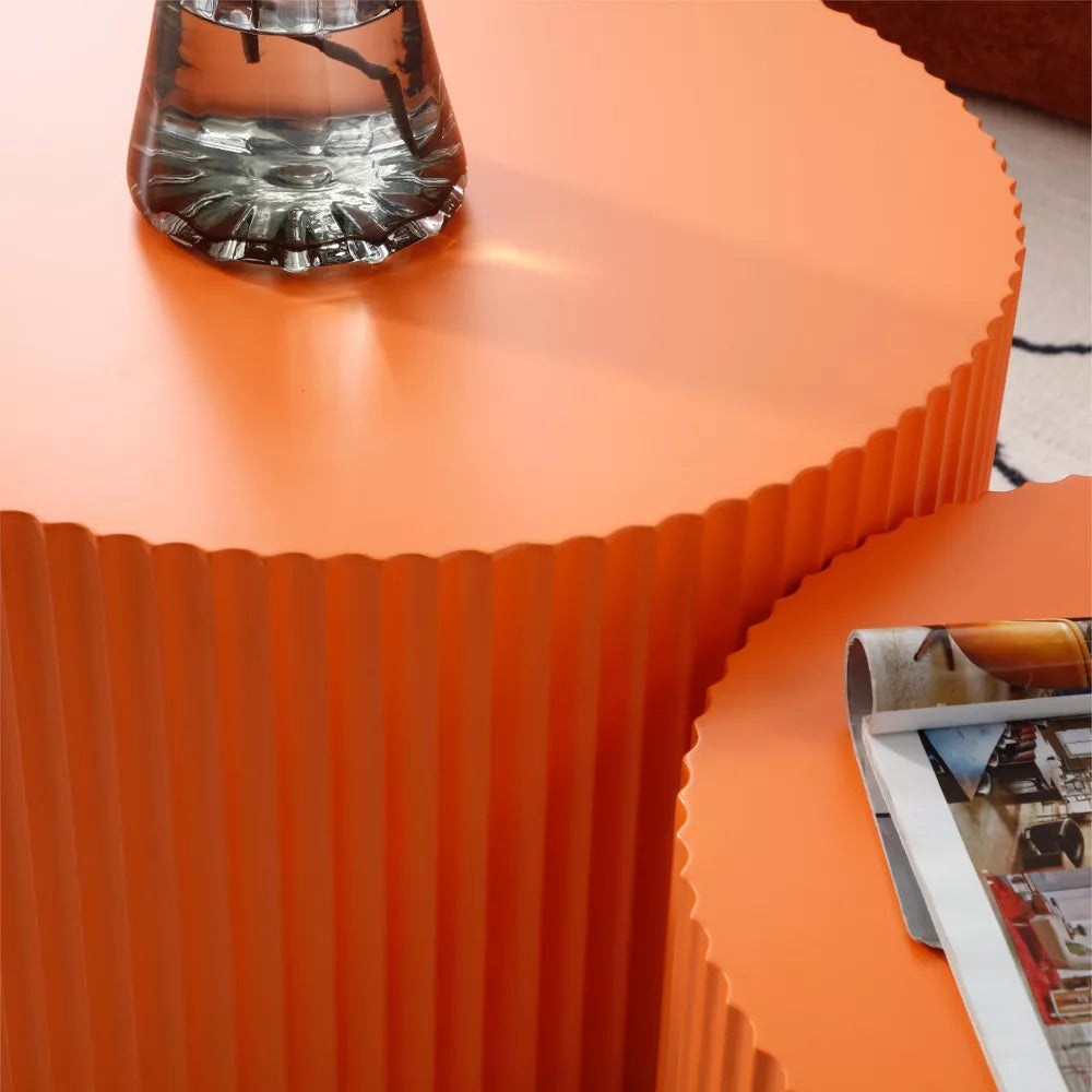 Close-up of an orange textured container with a clear lid on a light background orange