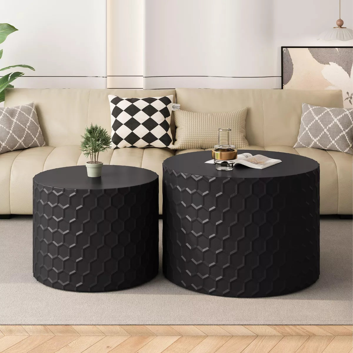 Two black textured side tables in front of a beige sofa with decorative pillows. black