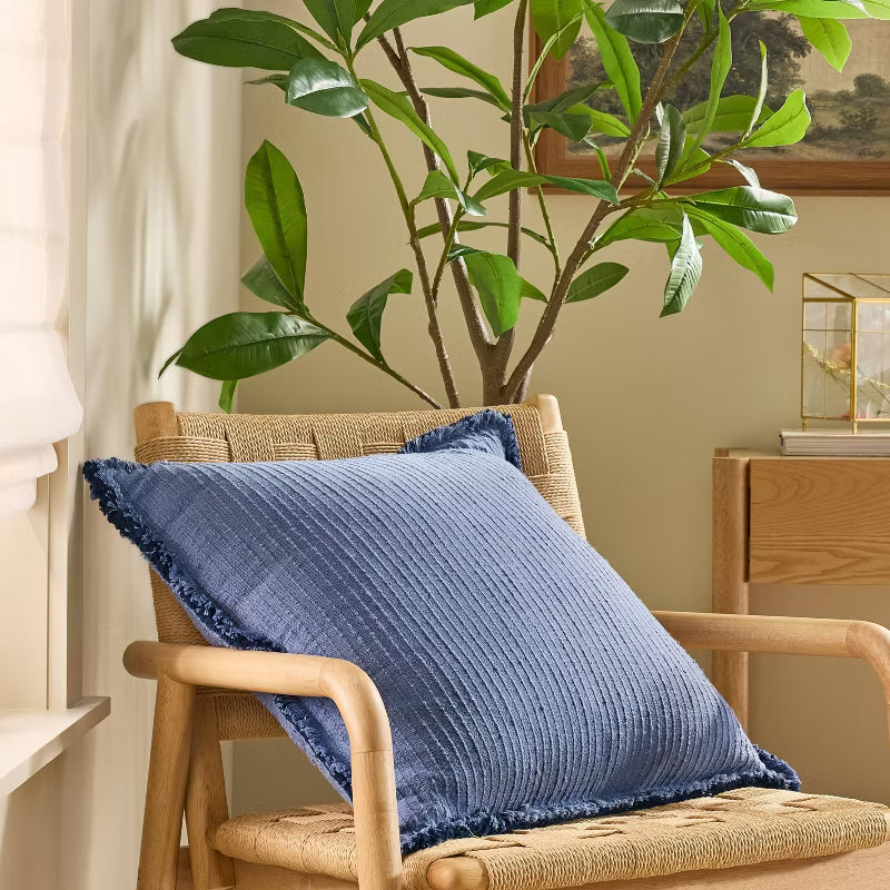 Blue textured blanket with frayed edges on a gray background Navy