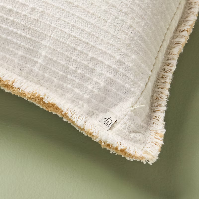 Textured fabric blanket with frayed edges on a green background Sour Cream