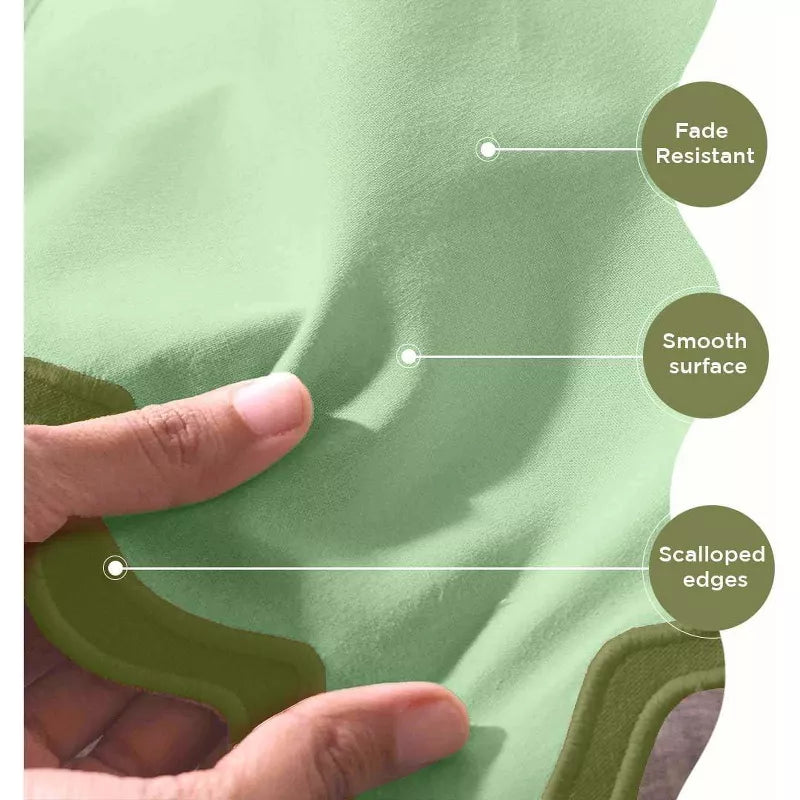 Green cushion with hand touching it, labeled for fade resistance, smooth surface, and scalloped edges.