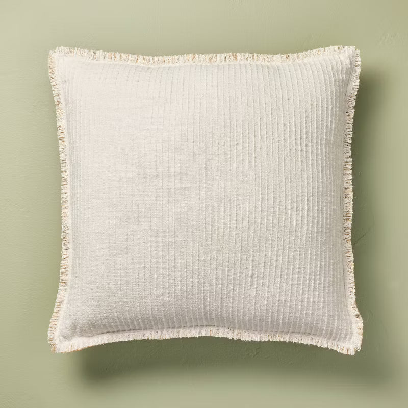 Textured fabric blanket with frayed edges on a green background Sour Cream