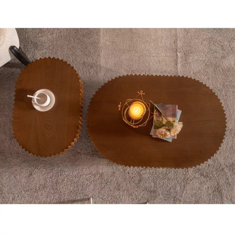 Wooden coffee table with a textured surface, featuring a book and flowers on top.