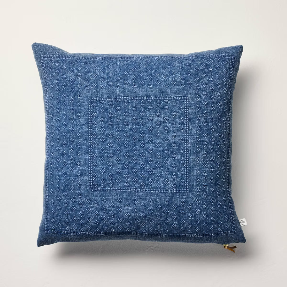 Blue textured pillow on a light gray background Navy