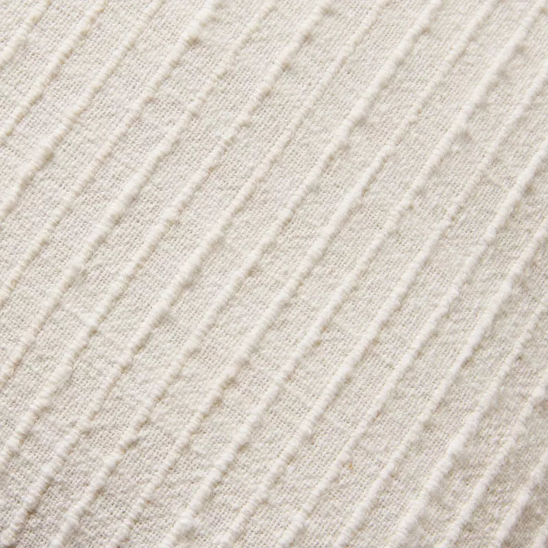 Textured fabric blanket with frayed edges on a green background Sour Cream