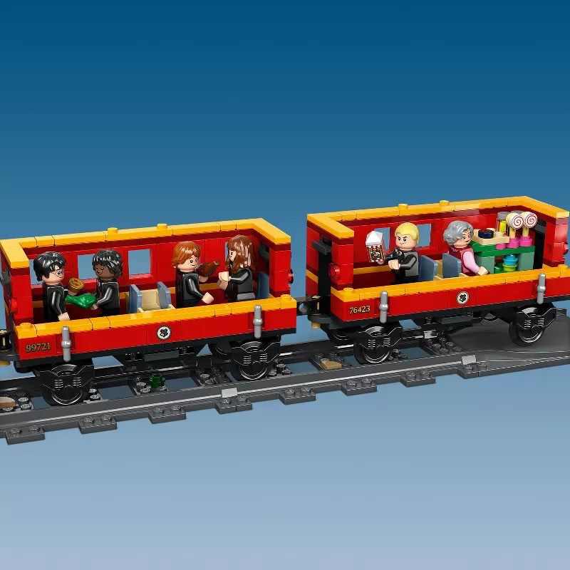 LEGO train set with red and yellow cars on a blue background