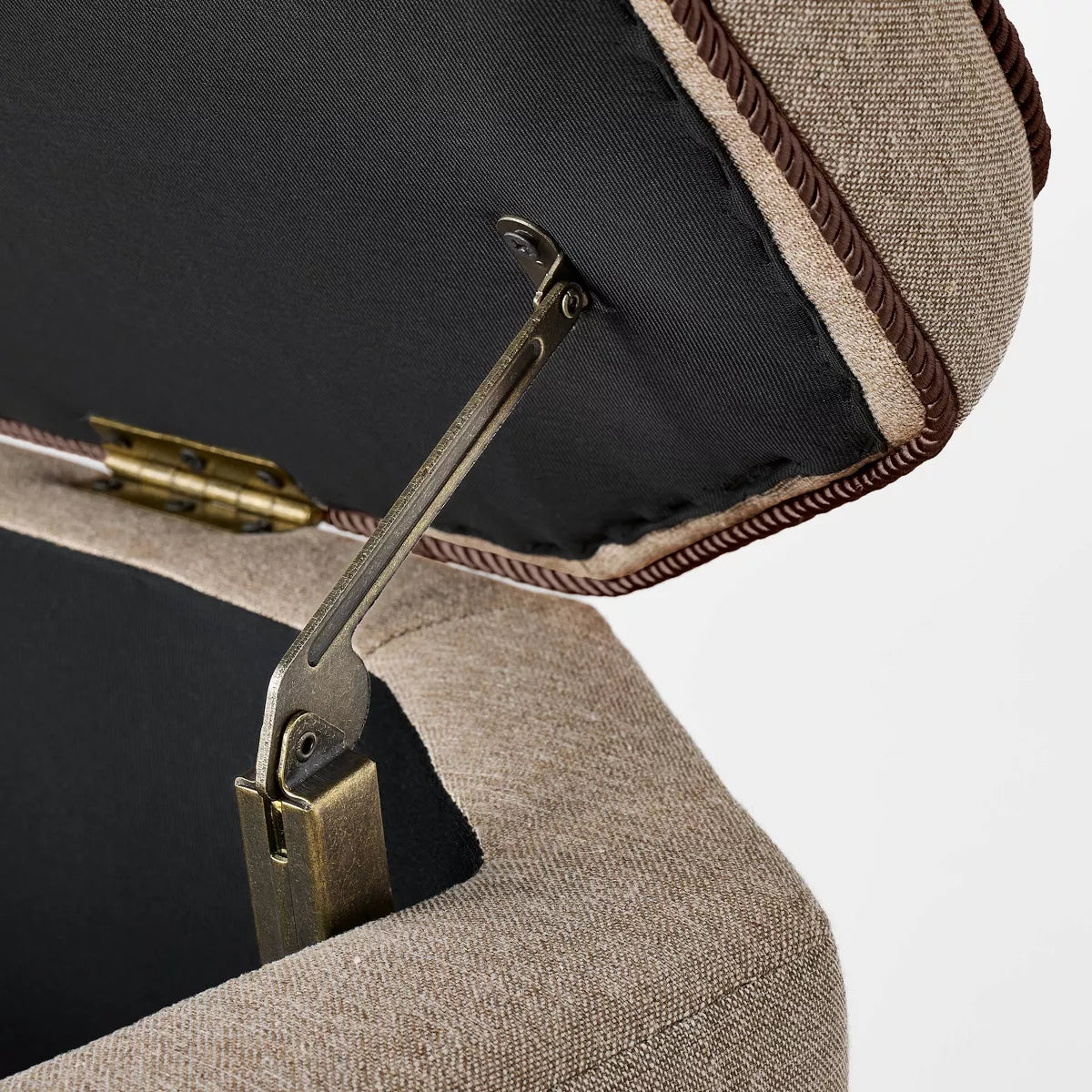 Close-up detail of twisted piping and metal hinge on the storage bench